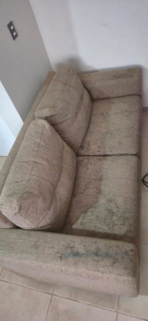 Sillón de tela con manchas y suciedad antes del lavado